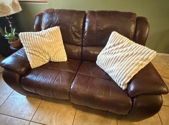 Comfortable dark brown leather reclining loveseat in very good condition.