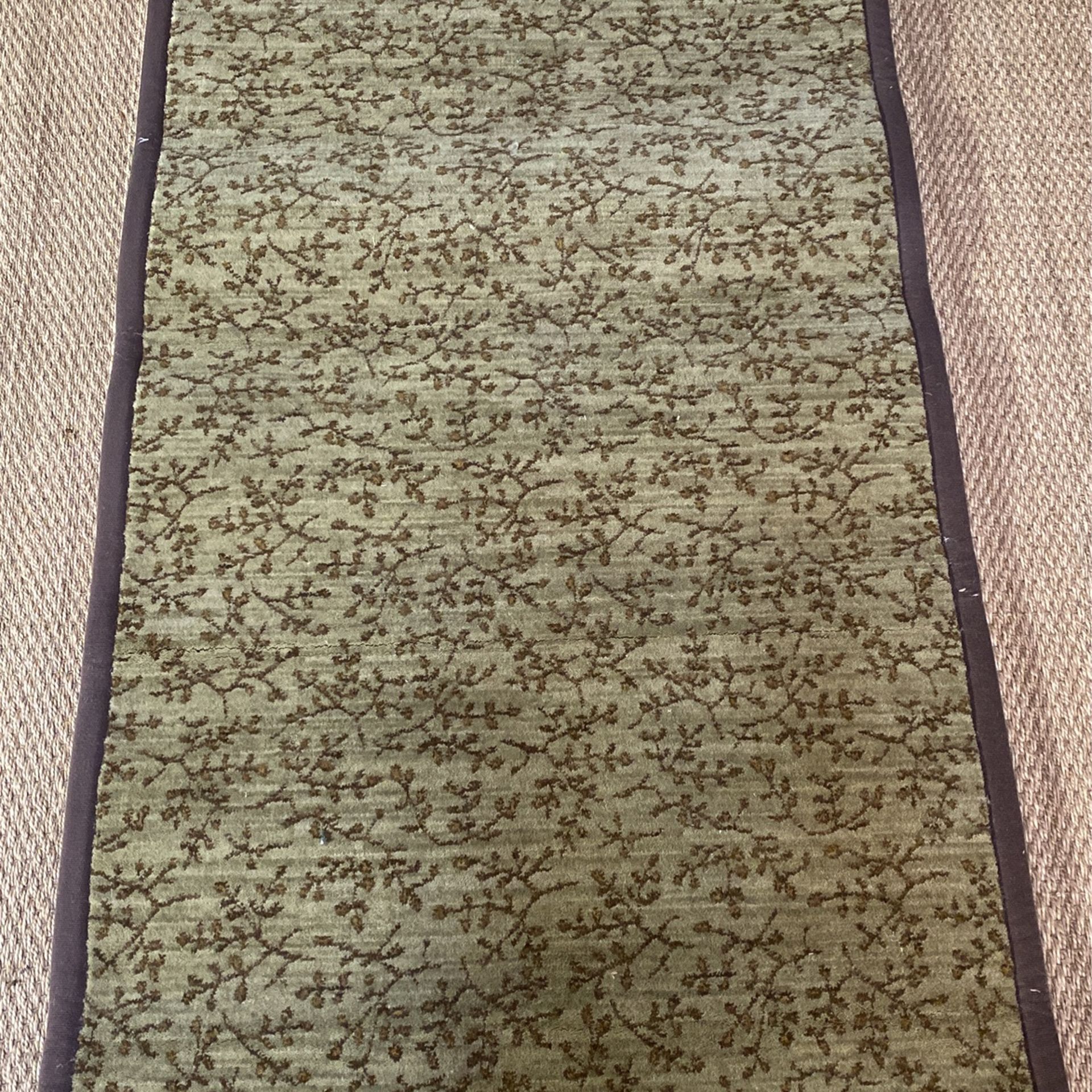 Olive patterned area rug hand bound