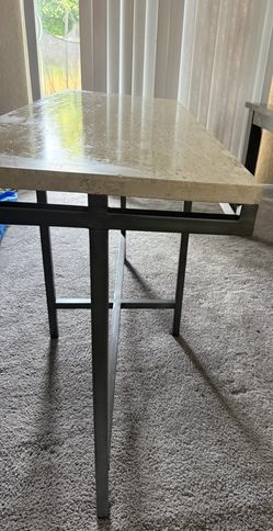 travertine console table with a dark steel frame