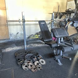 Adjustable Bench press with 250lbs of Olympic weights plus 7ft 45lbs bar