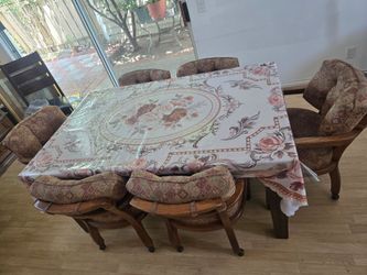 Table with six chairs and a piano