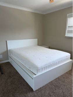 Bed frame with mattress and bedside table
