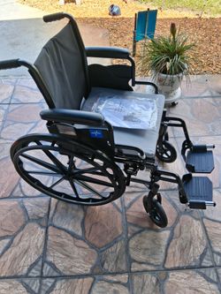 Medline Folding Wheelchair with Detachable Footrests. 18" Seat Width. Comes with Brand NEW Seat Cushion, Instructions and Wrench for adjustments.