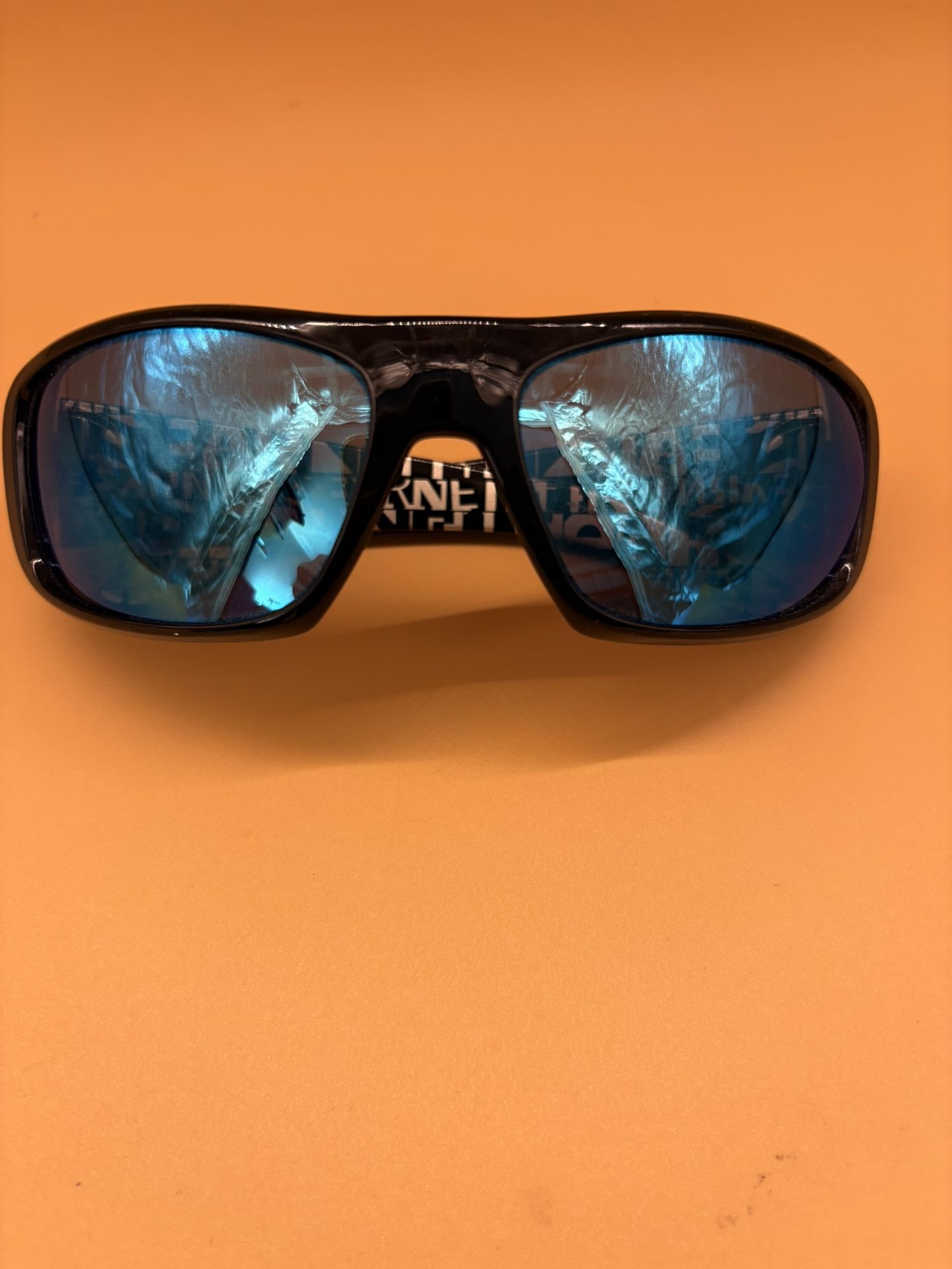 Black Arnette sunglasses with blue mirror lenses