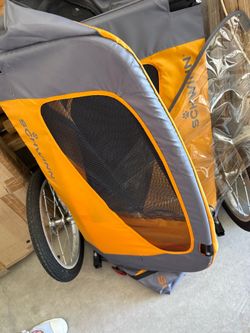 Child carrier- Schwinn will hold up to two children or two pets brand new never used hooks on the back of your bicycle has orange with a Ziploc top an