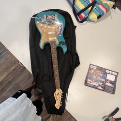 Rockwood Pro by Hohner RP150G electric guitar w/ Ibanez Amp IBZ10B  & soft guitar case.  Guitar works but has stickers and writing on it from previous