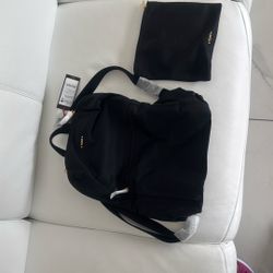 TUMI Black Just In Case Backpack. 98% Nylon With 2% Leather Trim And 100% Polyester Lining.