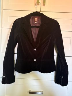 Black velvet blazer with rhinestone buttons.