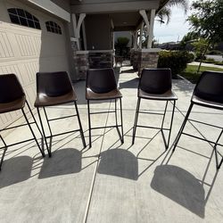 Brown modern faux leather bar height stools. With back and metal legs