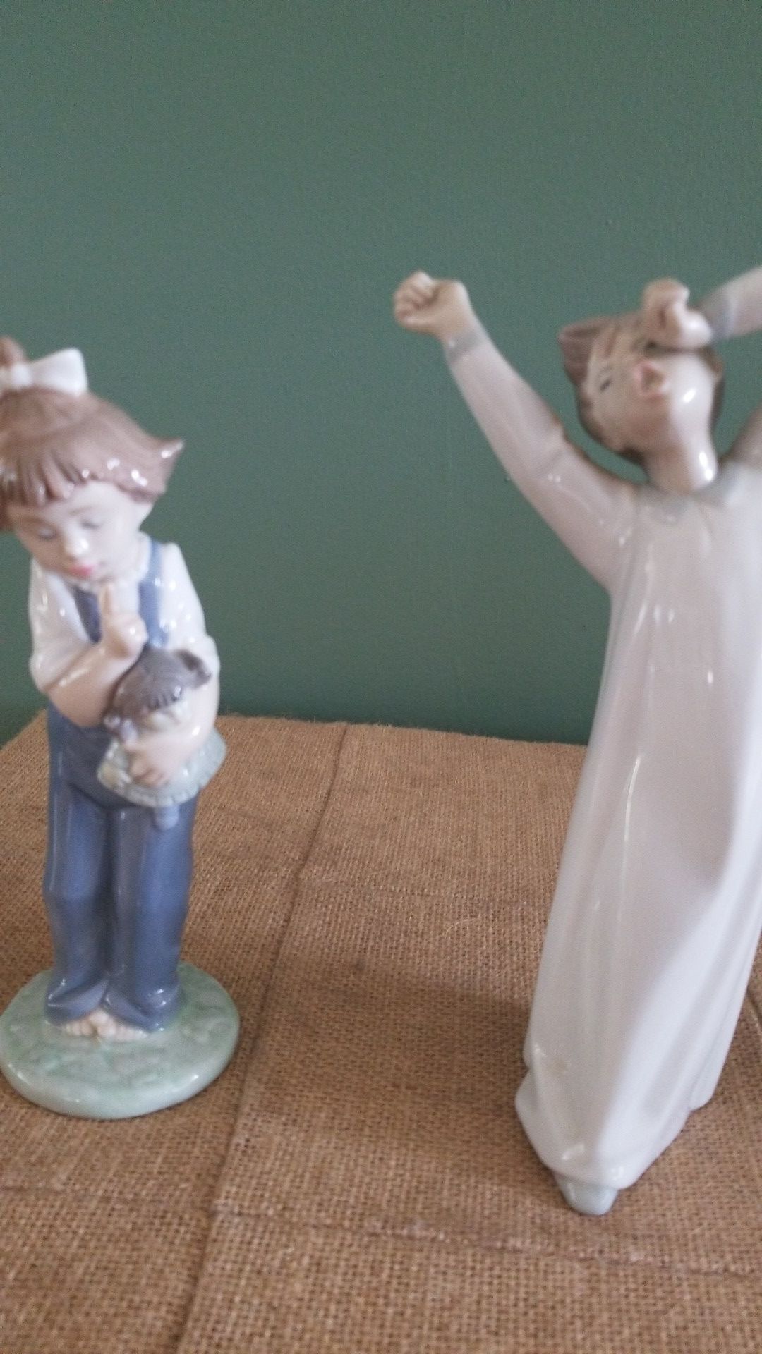 Lladro boy and Nao girl figurines.