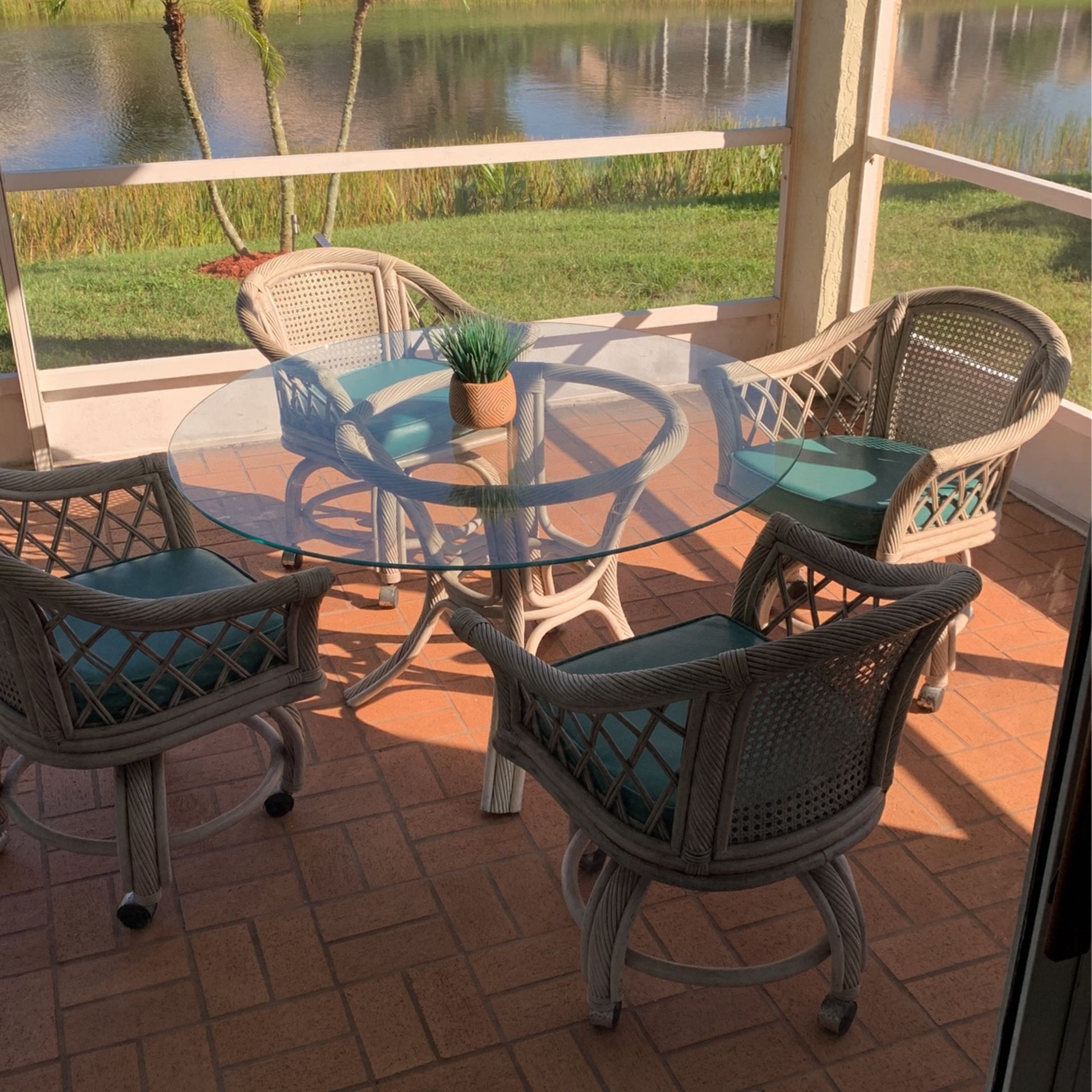 48 Inch Outdoor Round Table And 4 Wicker Chairs With Wheels for Sale in