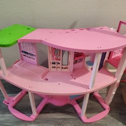 Barbie Dreamhouse, specifically the Pool Party Doll House model featuring a three-story slide. 