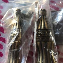 Two Coca Cola drawer pull handles