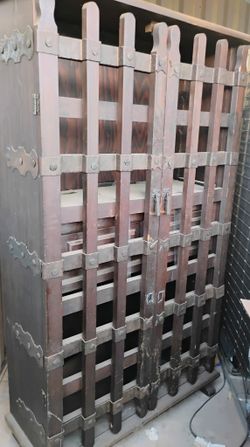 antique shelf with jail cell doors