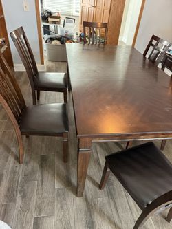 Dark Brown wood dining table Includes 6 cushioned chairs 
