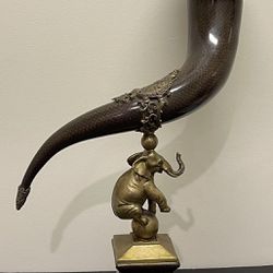Castilian ornamental brass and porcelain elephant drinking horn/vase.  26” high in excellent condition. Very heavy.