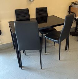 Black glass table with 4 chairs
