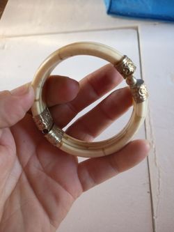 A Brass tone Bone Bangle Bracelet