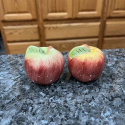 Vintage Apple Ceramic Pair of Salt And Pepper Shakers. Size approximately 2 1/4 inches tall. Preowned. Has been on display in a cabinet with a very