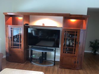Large Wooden Entertainment Center with Glass Doors and Pull-Out Storage
