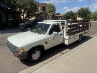 1991 Toyota pick up truck with a 10 foot flatbed door wheels Tommy liftgate five speed V6 98K miles have clean Arizona title on hand removable side ra