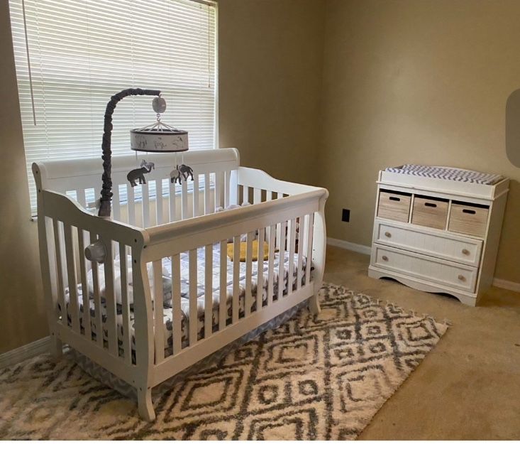 Includes a crib with Matress and protective cover with mobile and a changing table cushion, cover , dresser with storage baskets.