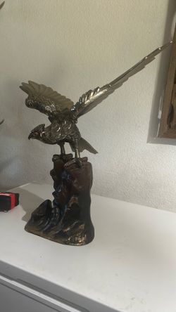 Pure metal eagle sculpture stands 19 inches tall 20 inches wing span.