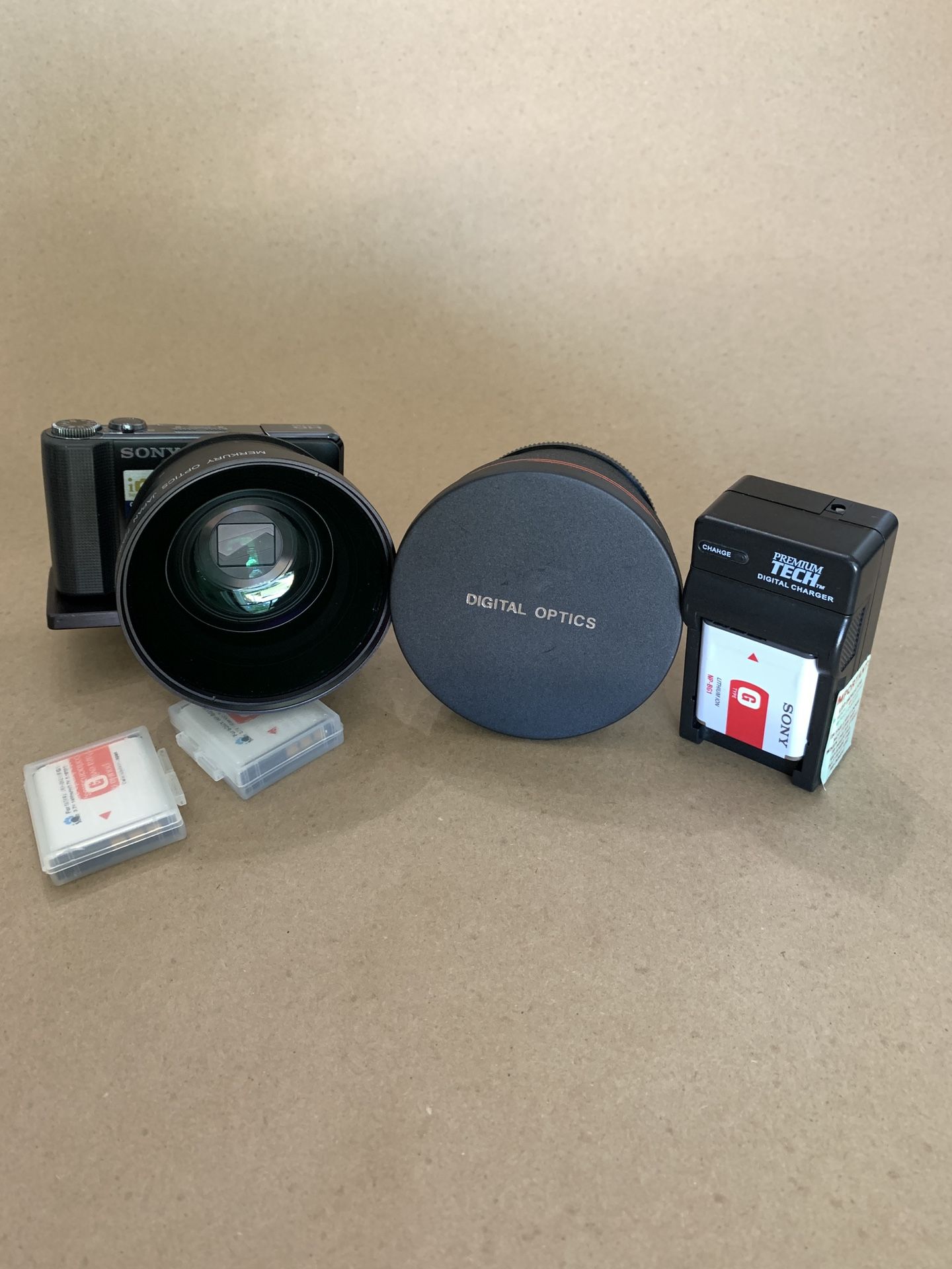 Sony dsc-hx9v Cyber-shot camera with special bracket that holds the camera and lens. 3 battery’s & charger 2 lenses