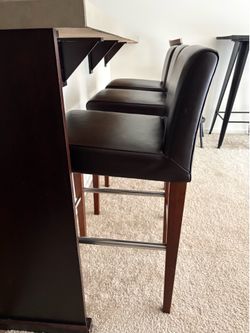 Three brown barstools
