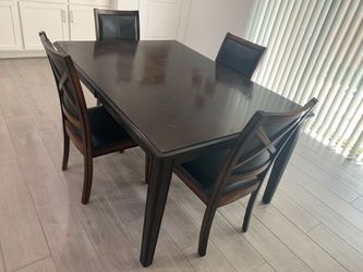 Dark wood dinning table with 4 chairs