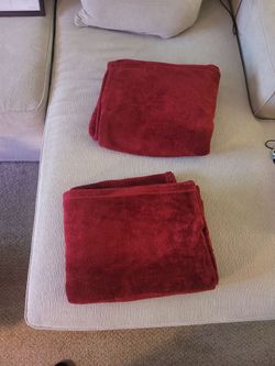 Two red throw blankets