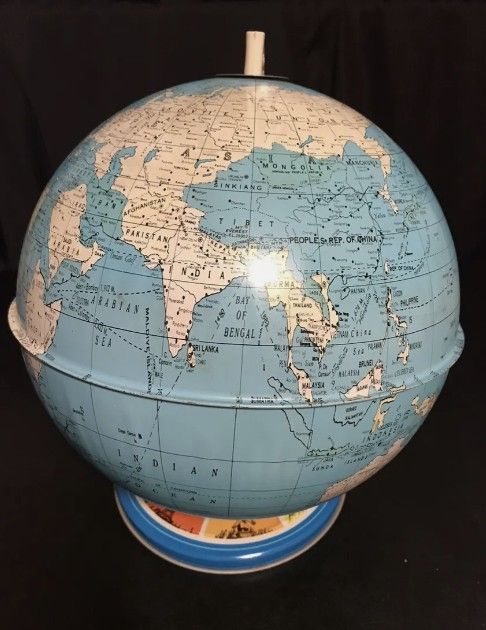 Vintage Ohio Art Company Tin World Globe with landmark base.