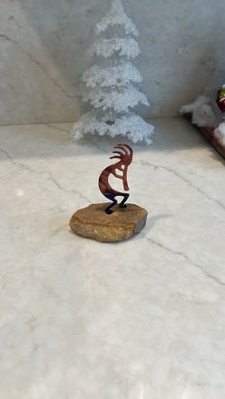 Kokopelli metal art in sandstone Christmas