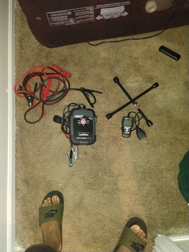 Battery Charger , Engine Reader, Jumper Cables, Tire Rod 4way ,and gas jug.