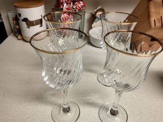 4 wine glasses with a gold rim