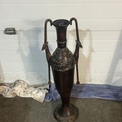 Vintage bronze colored metal vessel vase 29”T with animal shaped handles and decorative patterns