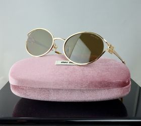 Miu Miu Logo Oval Sunglasses in Gold with Brown Lenses