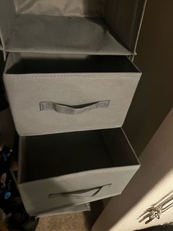 Three grey clothing organizers
