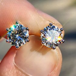 2 Carat Moissanite Round 18kt White Gold Plated Sterling Silver Stud Earrings.