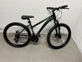 Black and green Schwinn Sidewinder Mountain Bike 26-inch wheels, front suspension, discs.