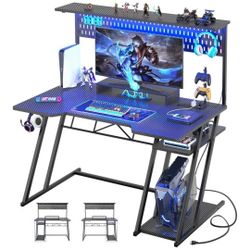 BRAND NEW 
Armocity Gaming Computer Desk with Shelves and Outlets, Gaming Desk with Hutch and LED Lights, Reversible PC Gaming Desks with Pegboard, Ca