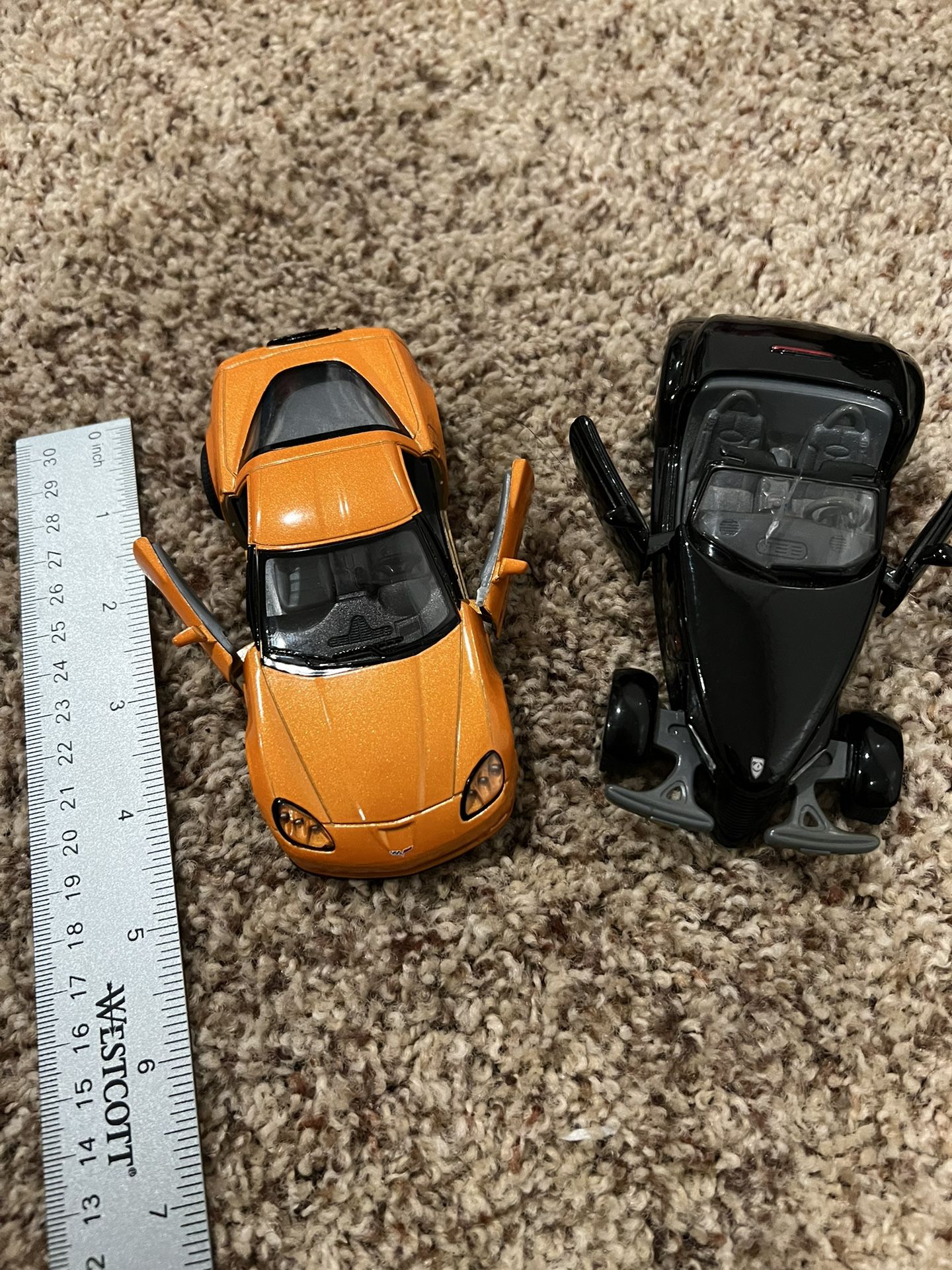 2 collectible cars ( black car’s glass is cracked )