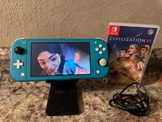 NINTENDO SWITCH LIGHT WITH A GAME AND USB  CHARGER CORD AND HOLDER INCLUDED / WORKING GREAT