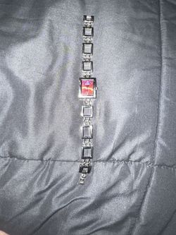 watch featuring a rectangular pink dial