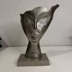 metallic face sculpture