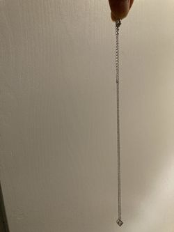 Designed with a white metal Necklace and small, square, transparent stones.very Beautiful 