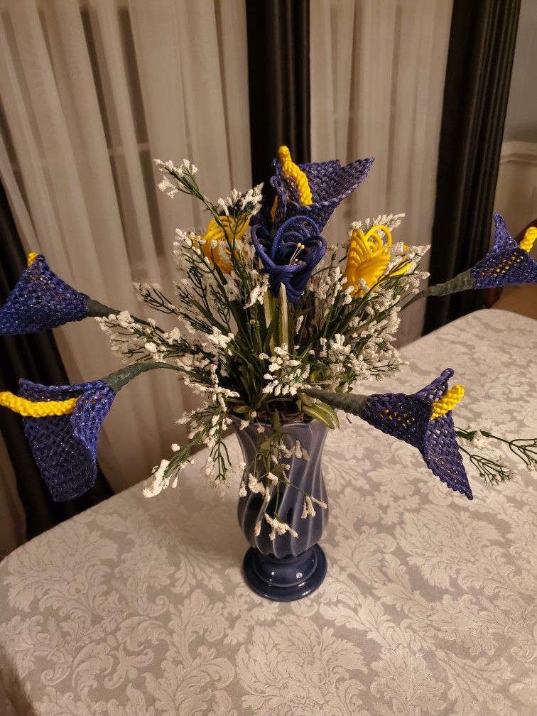 Artificial flowers with a blue vase