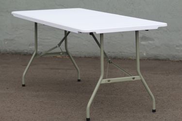 White fold out tables and black tables cloths