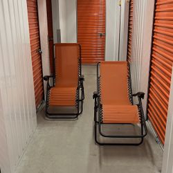 Two Orange Lawn Chairs 