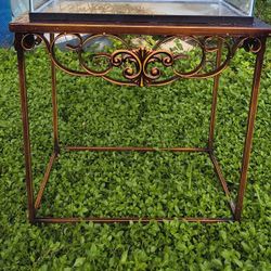 vintage wrought iron and glass console table,  copper finish, featuring ornate scrollwork. 